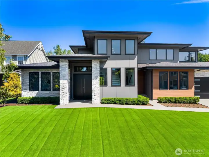 Architecturally stunning custom residence showcasing clean modern lines, natural stone detailing, and sophisticated design.