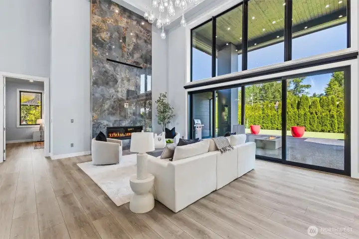 20-foot high glass wall incorporating 8-foot high 16-foot wide multi sliding glass doors  allowing for 12-foot expansive opening to covered patio.