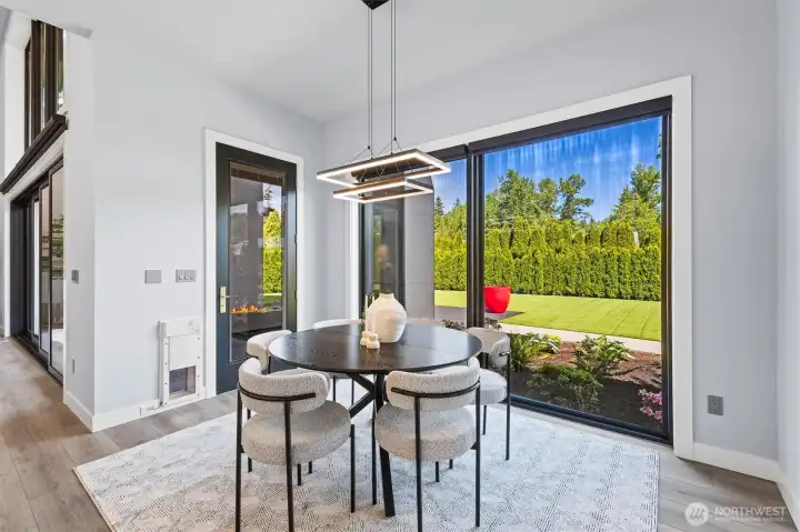 Dining area with expansive glass wall to rear landscaping.