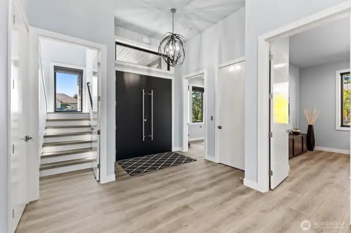 A stunning foyer sets the tone with clean lines, expansive sightlines, and sophisticated designer touches.