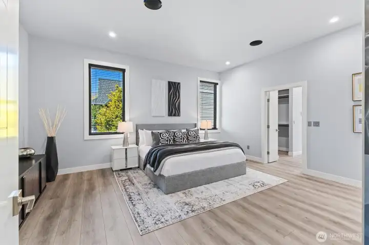 Expansive primary bedroom has built in speakers.