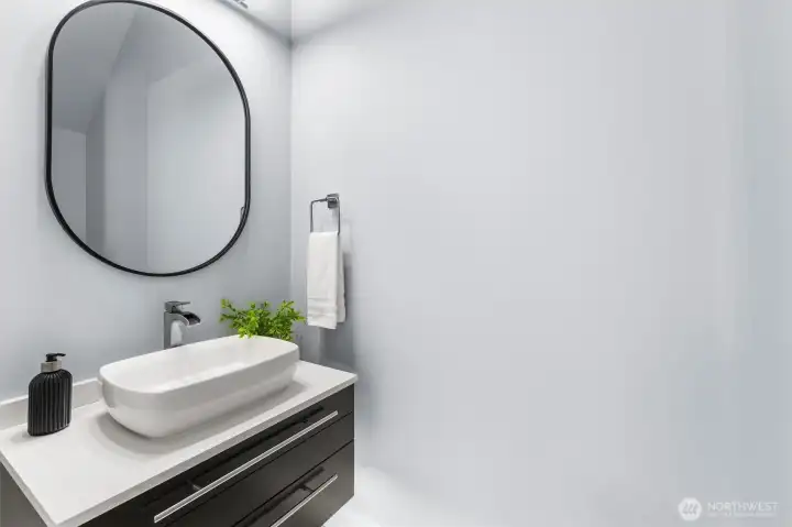 Wall hung vanity with indirect lighting in an additional main level half bath.