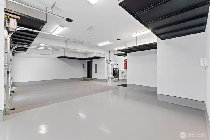 11-foot ceilings in garage with suspended powder coated metal hanging 4-foot deep storage shelving.