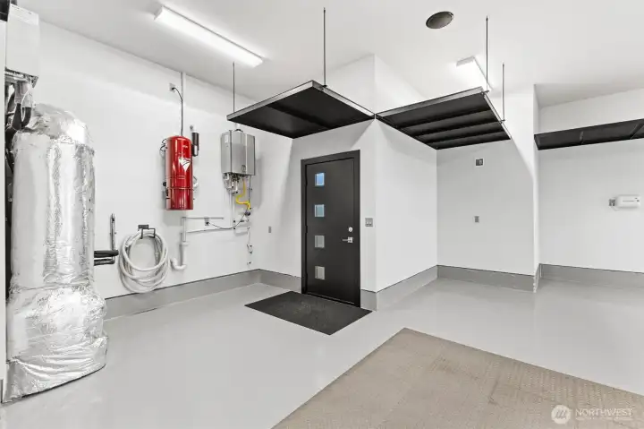 Garage features extra-quiet overhead wall mounted garage door openers and multiple ceiling sound speakers pre-wired.