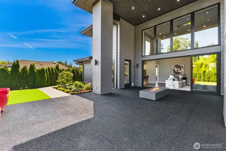Covered rear patio with 20-foot ceilings, gas fire pit and gas hookups for grilling.