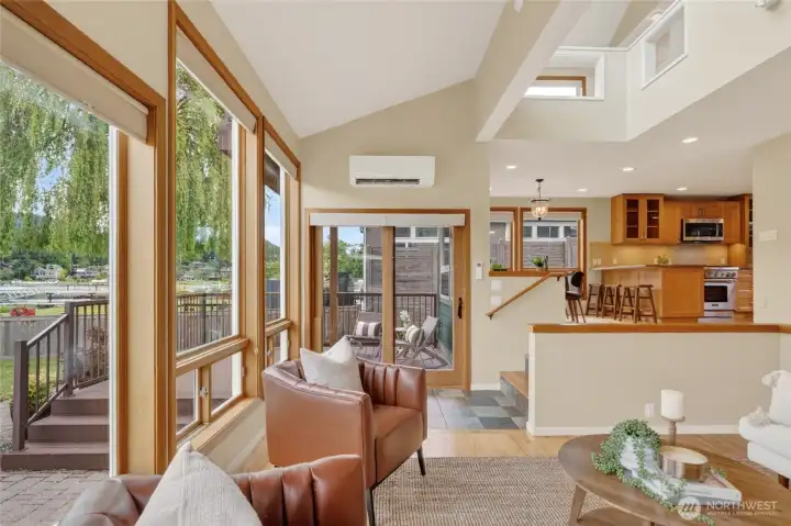 Wood clad sliding door in the background leads you do the deck and backyard patio