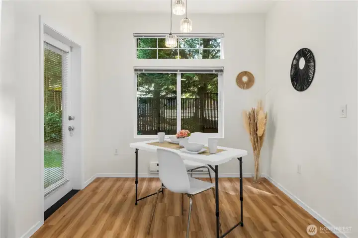 Dining Area with new light fixture and door to Private patio