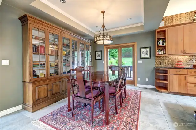 Dining room off kitchen with french doors to back sitting area.