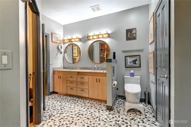 View of primary bath from the shower. Walk in closet to the left, additional closet space to the right.