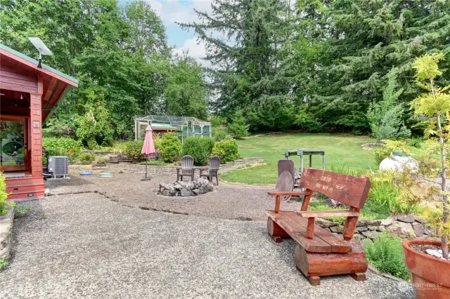 Sitting area in back yard with firepit. The property goes back into your treed area. Treed area is cleaned out to walk through.