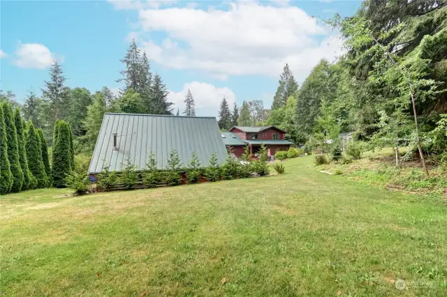 Back of property looking to the garage/shop. Huge garage upstairs storage area with elevator to lift things to upper floor.