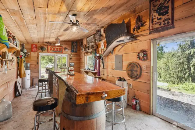 Covered outdoor BBQ area overlooks barn and arena