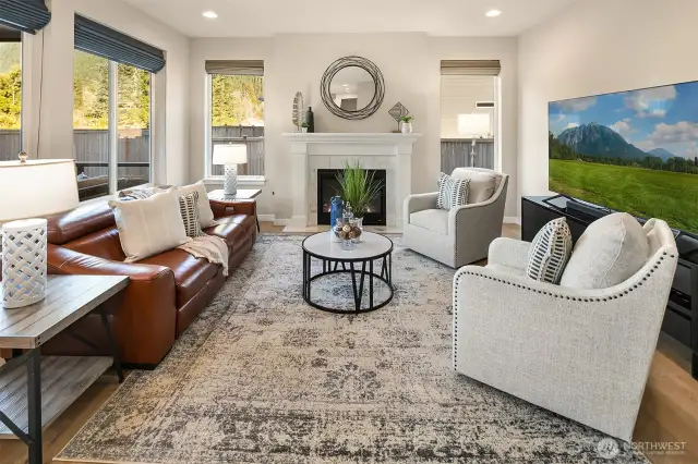 Warm, welcoming layout with wide plank hardwood floors on main level and recessed lighting throughout