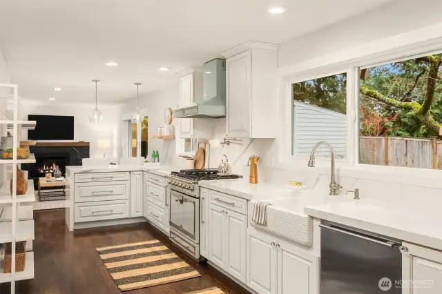 This stunning kitchen boasts sleek soft-close cabinets with sparkling countertops and stainless appliances.