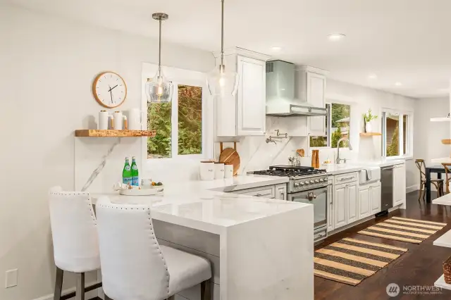 A different perspective from the eat-in kitchen area. Light and bright with picture window views of the surrounding flora.