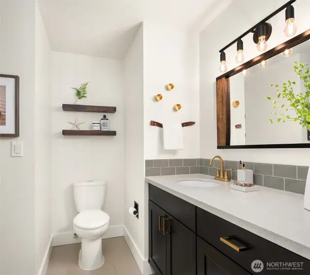 The efficient guest bath just off the upstairs hallway offers an oversized vanity and full-length mirror with generous under-counter cabinet space.