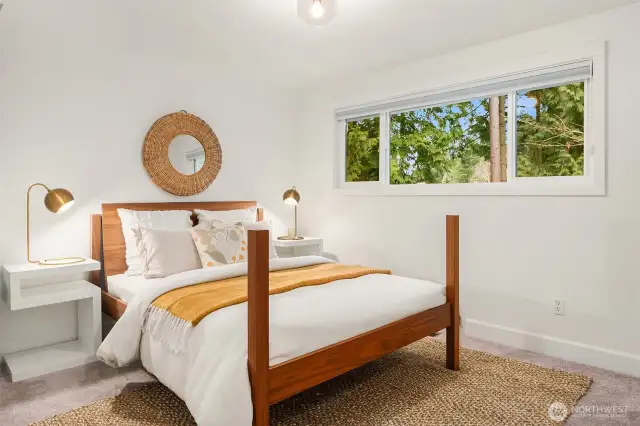 This second guest bedroom at the end of the upstairs hallway features a substantial picture window with custom black-out shade.