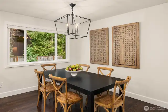 This cozy dining nook includes rear views of the productive and lush property grounds.