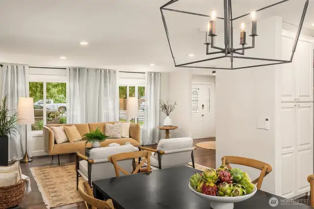 A different perspective of the formal living space from the dining area. Don't miss the beautiful stained glass features that highlight the front door.