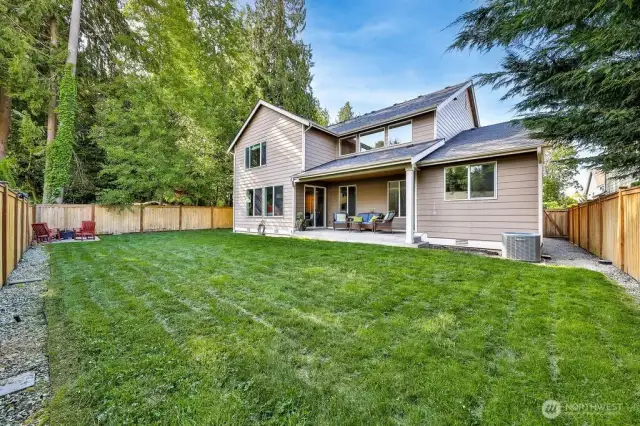 Expansive fenced backyard with with covered patio and firepit. Wide side yards on either sides.