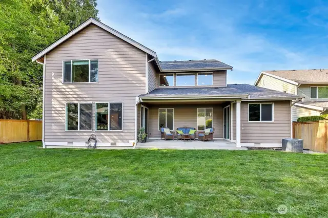 Expansive fenced backyard with with covered patio and firepit. Wide side yards on either sides.