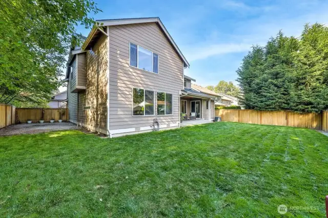 Expansive fenced backyard with with covered patio and firepit. Wide side yards on either sides.