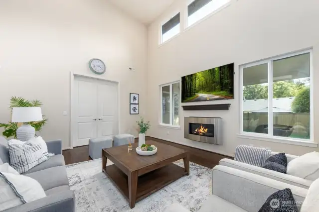 Soaring high ceiling/open to above great room with gas fireplace.