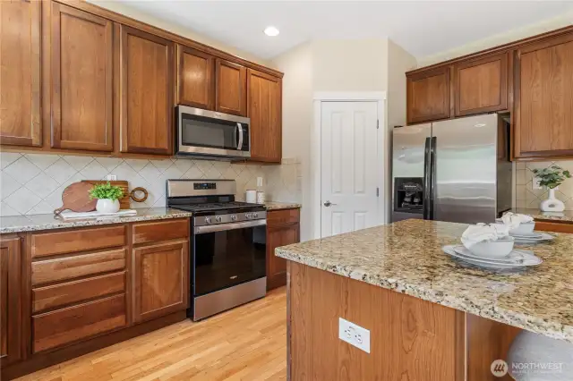 Enjoy this spacious kitchen with open sight lines to the family room! Large center island with breakfast bar seating, gleaming stainless steel appliances and a walk-in pantry