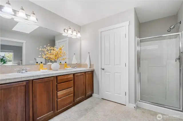 Primary en suite bath features double vanity, walk-in shower and separate toilet room