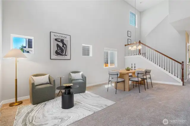 The living room and dining room feature open sight lines and soaring vaulted ceilings