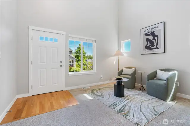 The living room is nicely sized with open sight lines and dramatic high ceilings