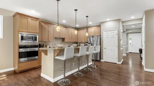 Chefs kitchen featuring granite counters, SS appliances, plenty of cabinets for storage and a large pantry