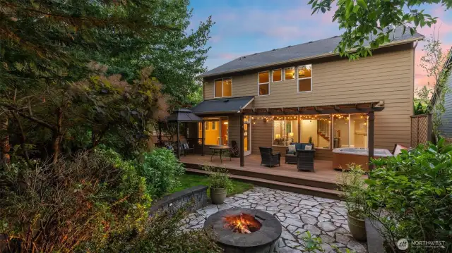 A glowing fire pit anchors the outdoor space, crackling beneath the open sky—perfect for cozy gatherings, toasted s'mores, and late-night conversations under the stars!