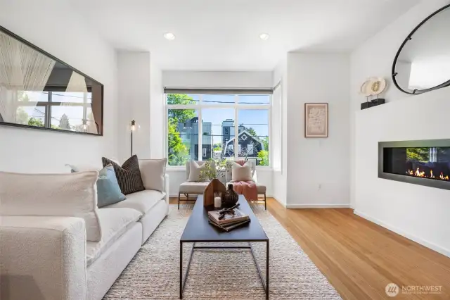 East-facing windows provide all-day natural light, and the open living room is anchored by a cozy gas fireplace.