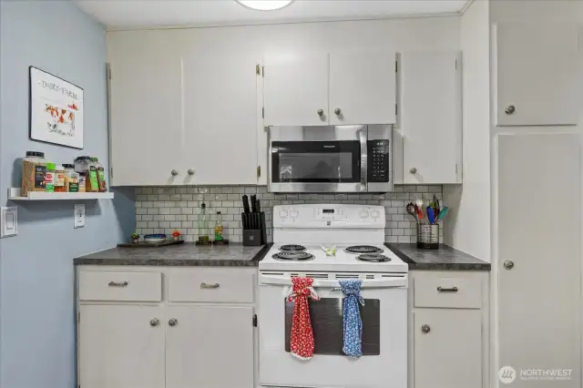 Stove/ cooking area on side of kitchen.