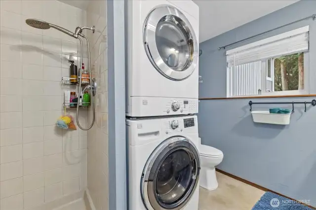 Shower and stackable washer dryer in lower level.