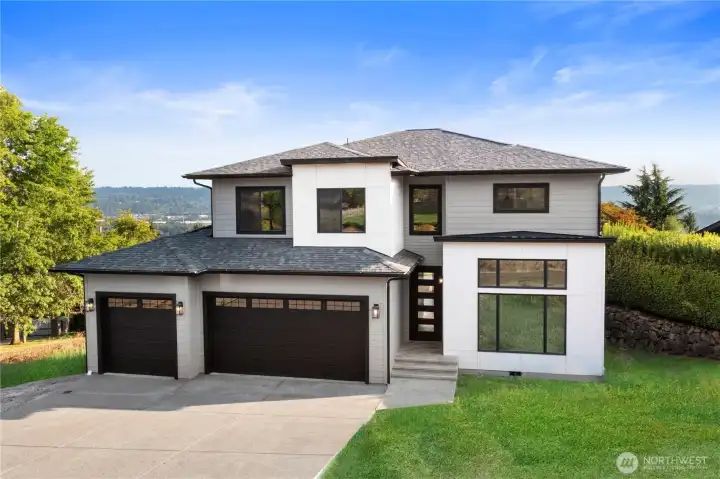 Luxurious new construction with stunning Mt. Rainier & valley views on a .50-acre corner lot. 3975 Square feet with 4 bedrooms and 4.50 bathrooms.  Enjoy a 420 sq. ft. vaulted deck plumbed for BBQ. Inside features 9' ceilings, Pecan hardwood floors, Craftsman trim, wood-wrapped windows & a 9’ x 8’ picture window. The gourmet kitchen includes quartz counters, soft-close shaker cabinets, an undermount sink, ZLINE gas cooktop, and top-tier Whirlpool stainless appliances. The primary suite offers a balcony, walk-in closet, and 5-piece bath. Upstairs boasts 4 bedrooms, a bonus room & office with closet. The finished daylight basement includes a full bath, separate entrance, is plumbed for a future kitchen, has a 400+ sq. ft. patio w/valley view & perfect for potential ADU/multi-generational living.  *Lawn virtually added