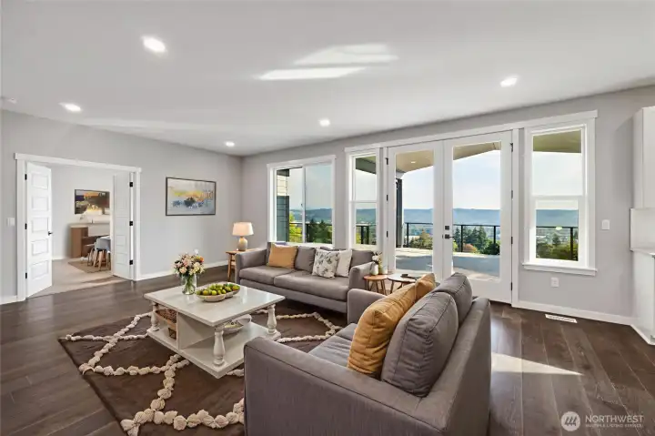 Check out this open living room with a tremendous view!  9' ceilings, Craftsman style trim package, wood wrapped windows throughout, structurally engineered Pecan hardwood floors and more!