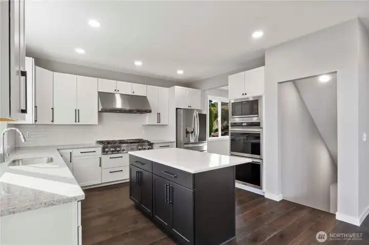 48" ZLINE gas cooktop, Straight NXR professional style stainless range hood, stainless double Whirlpool Galaxy wall convection ovens, Whirlpool microwave and dishwasher too!