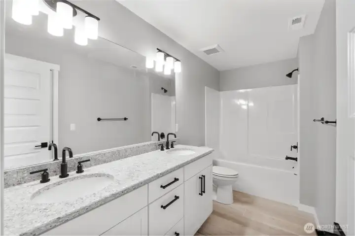 All bathrooms feature quartz counters and Moen Gibson bath fixtures.