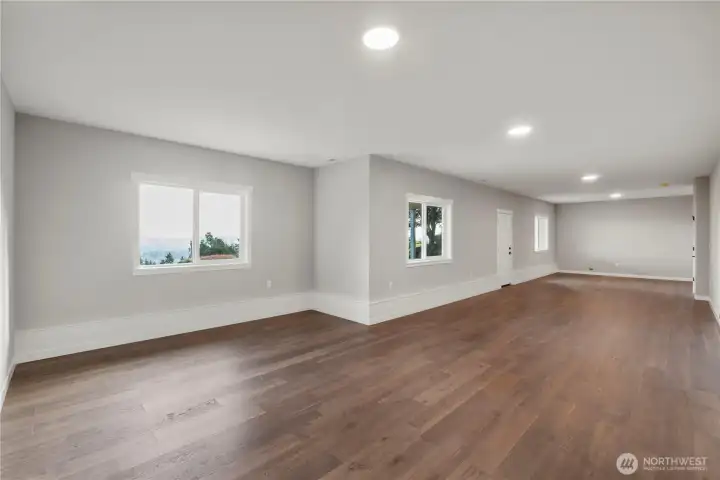 This lower level features 1000 square feet, its own full bath, a VERY open floorpan to accommodate multiple options, Wonderfloor hardwood flooring, a separate entrance, its own patio, AND is plumbed for water in the wall at the far end for wetbar or potential 2nd kitchen.  ADU or multi-generational living?