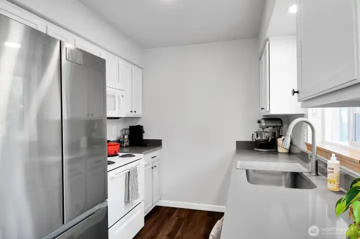 New stainless steel refrigerator, quartz counters, flooring, fixtures and refurbished cabinets. Must see!