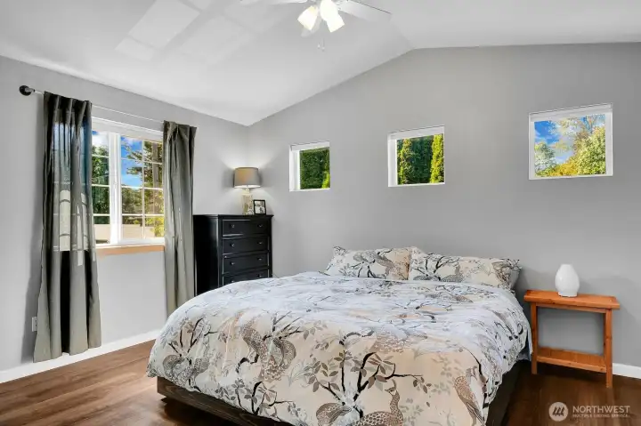 Primary suite with walk-in closet, new flooring, paint, ceiling fan and primary bath.