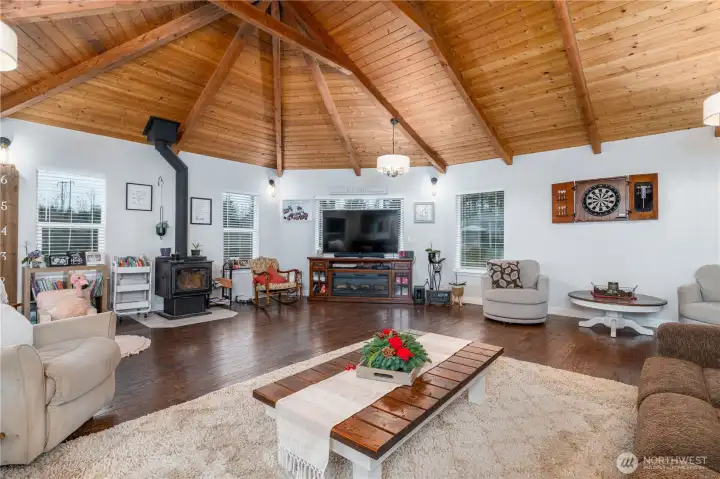 Spacious great room with newer woodstove and Oak hardwood flooring