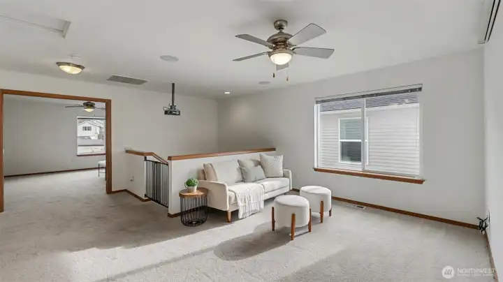 Versatile and open, this bonus room offers ample space and a built-in media setup—perfect for entertainment, gaming, or relaxing in style.