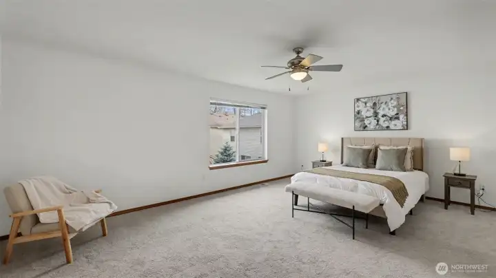 A spacious retreat featuring a ceiling fan and serene ambiance, designed for comfort and style.