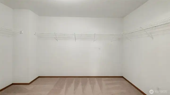 A massive walk-in closet offering abundant space and organization for a truly elevated storage experience.