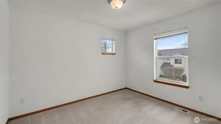 Bright and airy, this sunlit bedroom creates a cheerful and welcoming retreat.