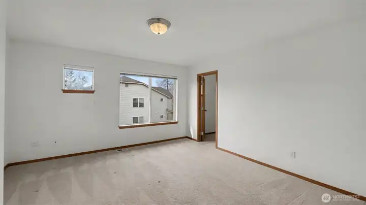 Generously sized, this bedroom offers plenty of room for a bed, desk, and personal touches.