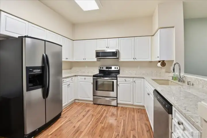 This home has a large kitchen with loads of cabinet and counter space and stainless appliances.  To the left of the refrigerator is a nice sized pantry that is not shown.